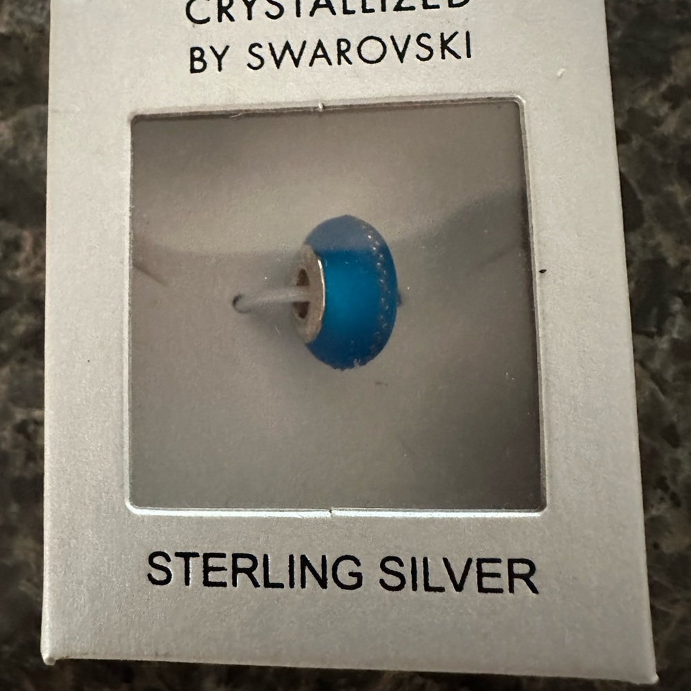 Chamila beautiful turquoise bead w/ thin silver zig zag running around the bead.
